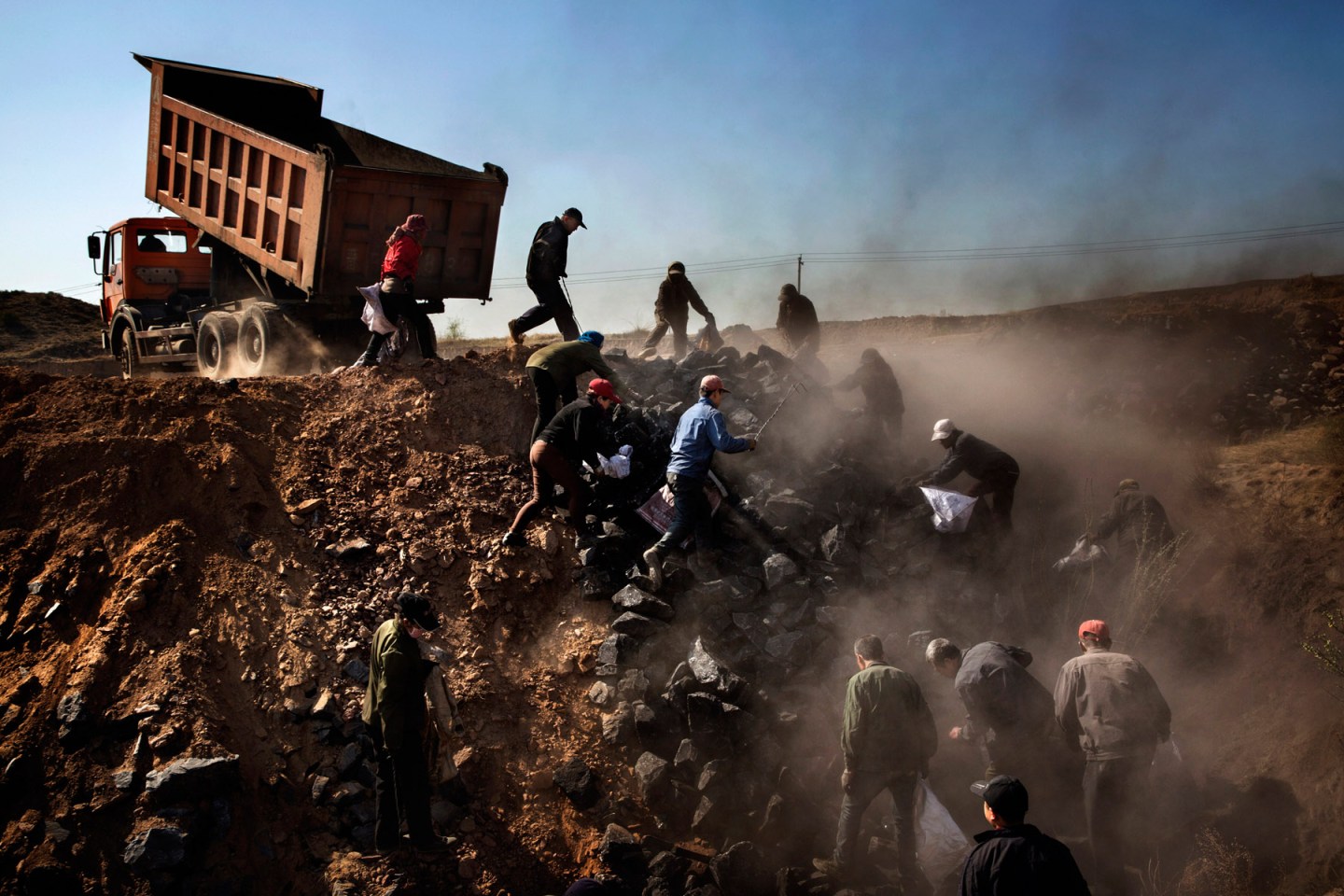 Villagers scavenge for discarded, low-grade coal