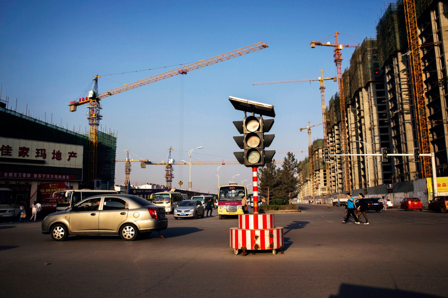 Traffic is seen in front of a construction site in New Ping Wang