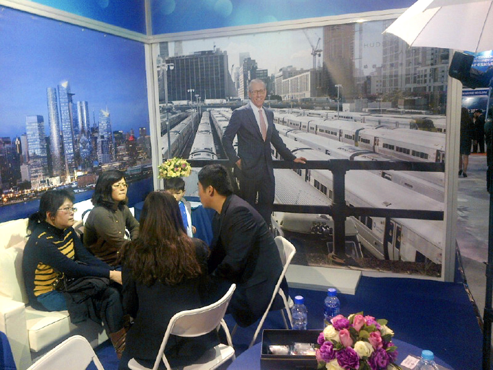 Related's booth at the Invest in America Summit EB-5trade fair in Shanghai, China. The portrait of Stephen Ross was originally commissioned for Fortune's story on their Hudson Yards project.