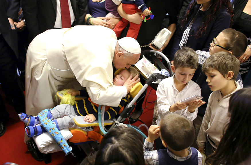 Pope Francis kisses a child during his pastoral visit at the parish church " Santa Maria dell'Orazione" at Setteville di Guidonia neighborhood of Rome