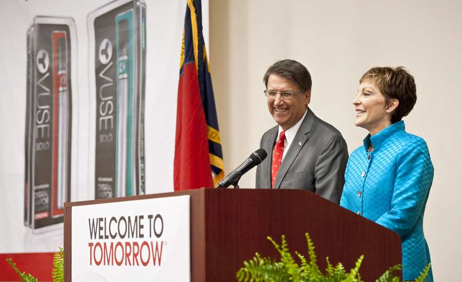 North Carolina Gov. Pat McCrory, left, and Reynolds American Inc. CEO Susan Cameron answer questions at a press conference, Friday, May 23, 2014, at Reynolds American's Tobaccoville, N.C., plant where the company announced 200 new jobs producing their Vuse brand electronic cigarette. (AP Photo/Winston-Salem Journal, Walt Unks).
