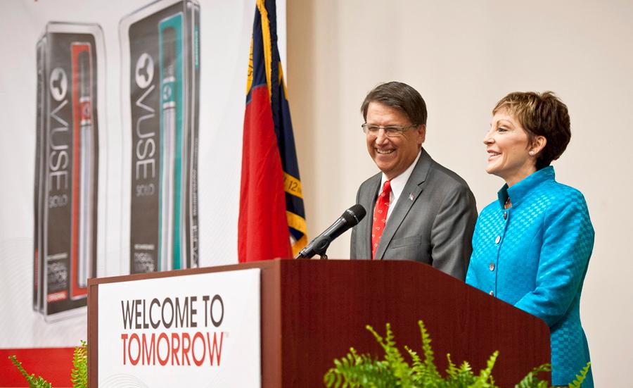 North Carolina Gov. Pat McCrory, left, and Reynolds American Inc. CEO Susan Cameron answer questions at a press conference, Friday, May 23, 2014, at Reynolds American's Tobaccoville, N.C., plant where the company announced 200 new jobs producing their Vuse brand electronic cigarette. (AP Photo/Winston-Salem Journal, Walt Unks).
