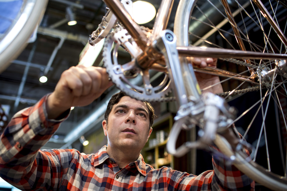 Steven Bock, owner of Detroit Bicycling Co. stands for a portrait with one of his handcrafted bikes, the Trumbull Street, in Detroit, on Oct. 3, 2014.