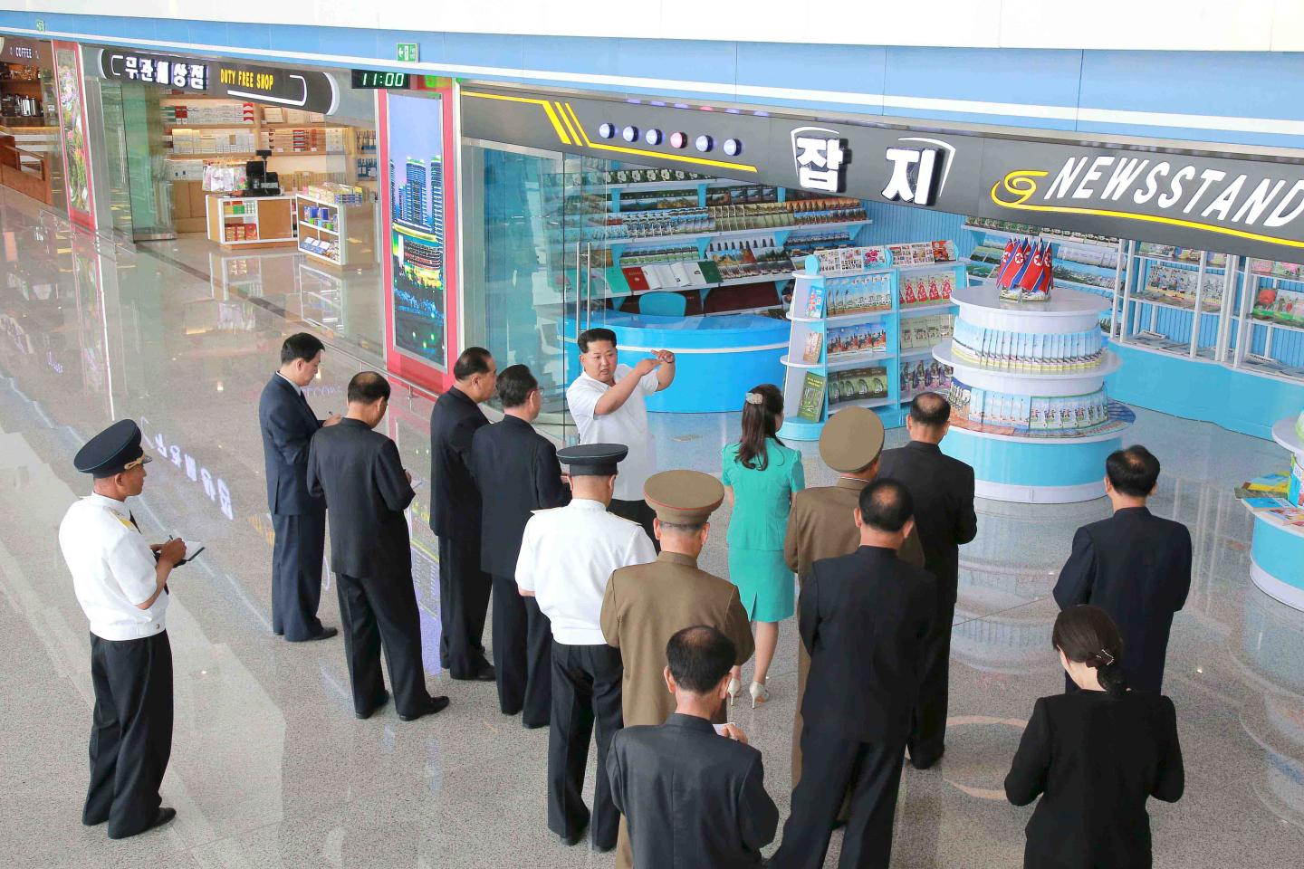 North Korean leader Kim speaks next to his wife Ri as he gives field guidance at the new terminal of Pyongyang International Airport