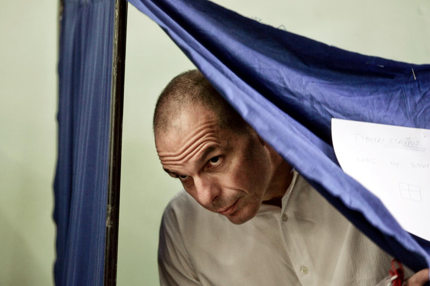 Greek Finance Minister Yanis Varoufakis leaves the voting booth after casting his vote in the referendum at a school in the suburbs of Athens on July 5, 2015 in Athens, Greece. The people of Greece are going to the polls to decide if the country should accept the terms and conditions of a bailout with its creditors. Greek Prime Minister Alexis Tsipras is urging people to vote 'a proud no' to European creditors' proposals, and 'live with dignity in Europe'. 'Yes' campaigners believe that a no vote would mean financial ruin for Greece and the loss of the Euro currency.