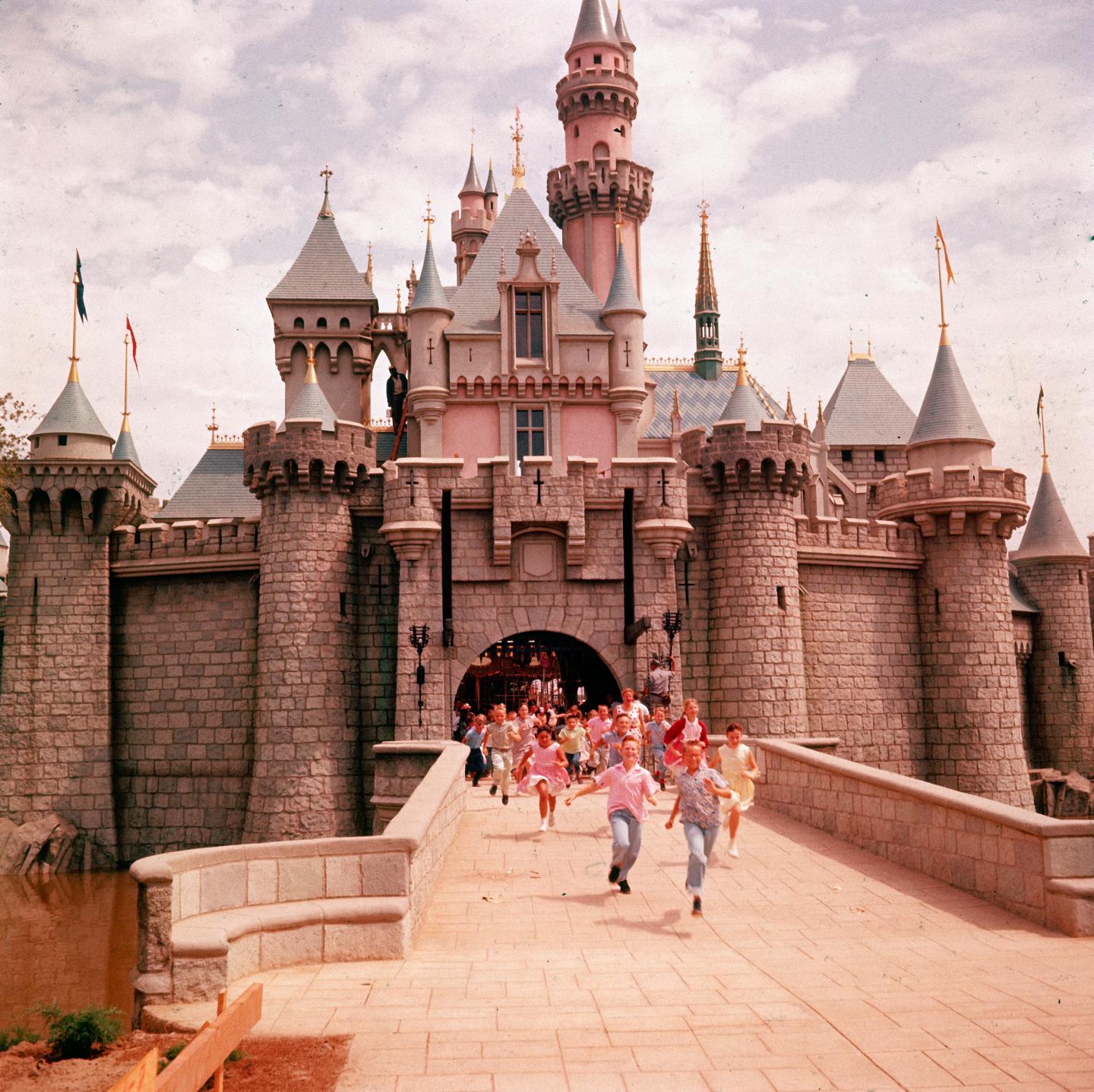 Children running through gate of Sleeping Beauty's