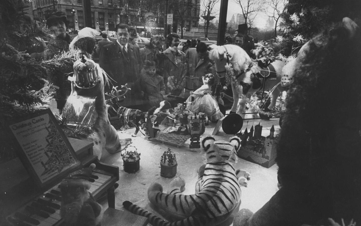 People looking in the windows at FAO Schwartzs toy store.