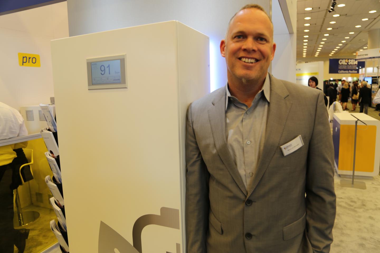The CEO of Sonnenbatterie, Boris Von Bormann, stands in front of the company's new battery for homes in North America at Intersolar 2015.
