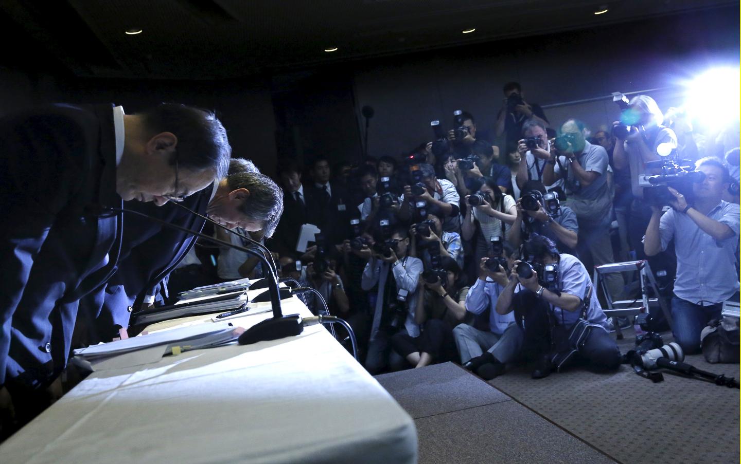 Toshiba Corp President and Chief Executive Officer Tanaka, Chairman of the Board Muromachi and Corporate Executive Vice President Maeda, bow at the end of news conference at the company headquarters in Tokyo
