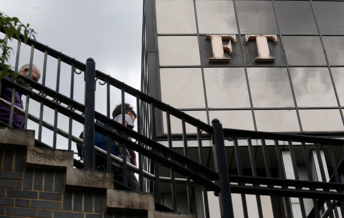 A company logo hangs on the headquarters of the Financial Times newspaper in London