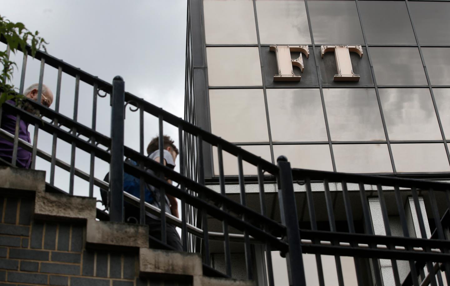 A company logo hangs on the headquarters of the Financial Times newspaper in London