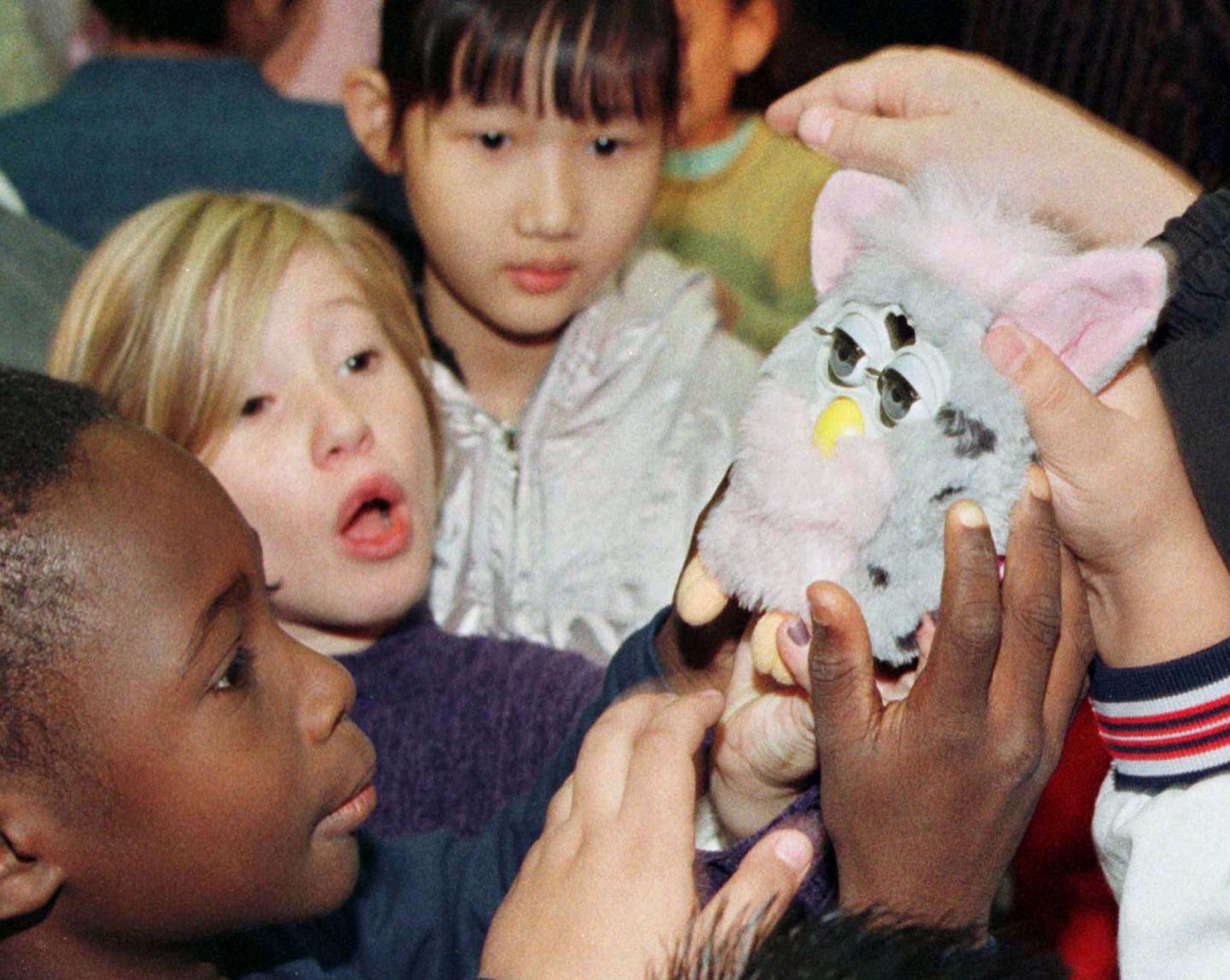 Children surround a "Furby" at the opening of the FAO Schwarz "Furby Shop" in New York on October 2...