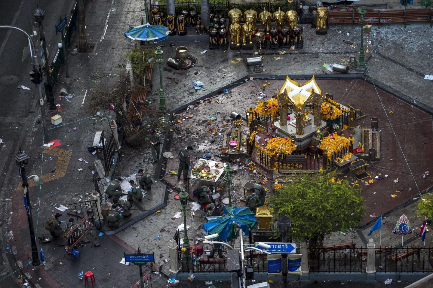 Experts investigate the Erawan shrine, the site of a deadly blast in central Bangkok