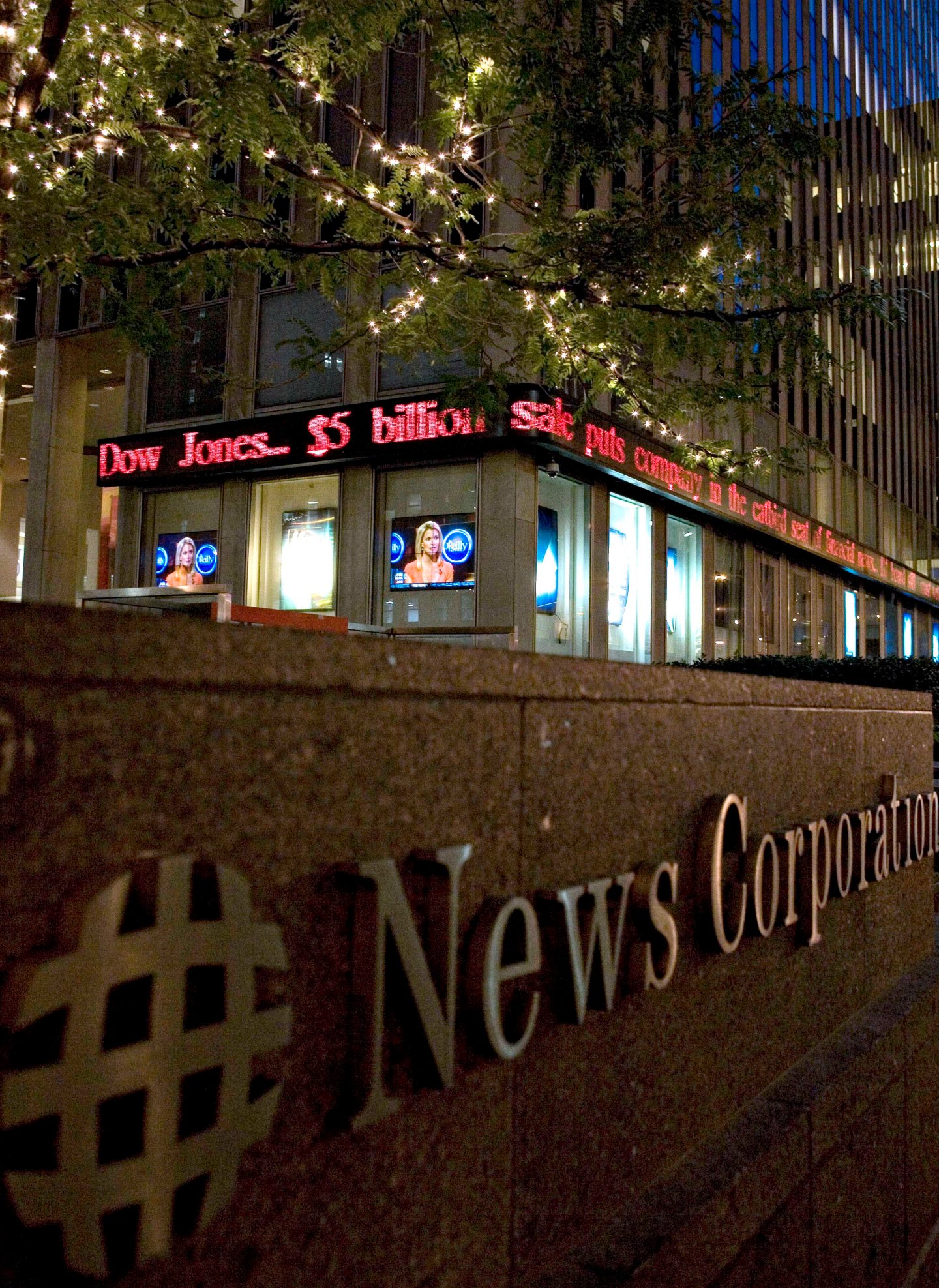 The headquarters of News Corp. displays headlines that the c