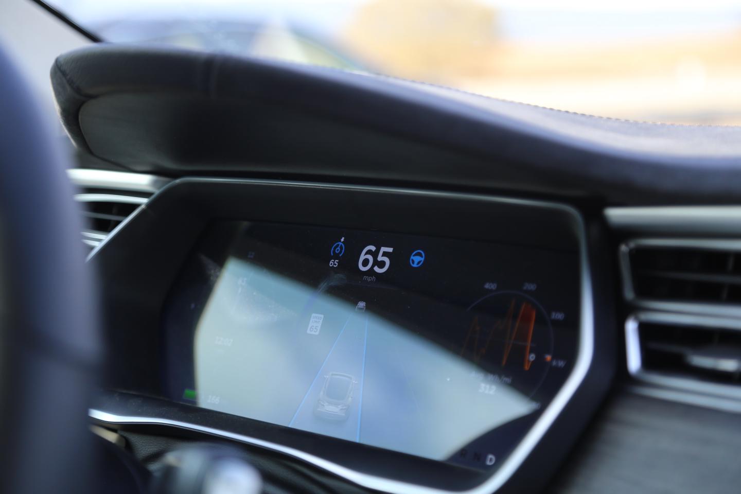 Tesla's autopilot mode is enabled in the photo.