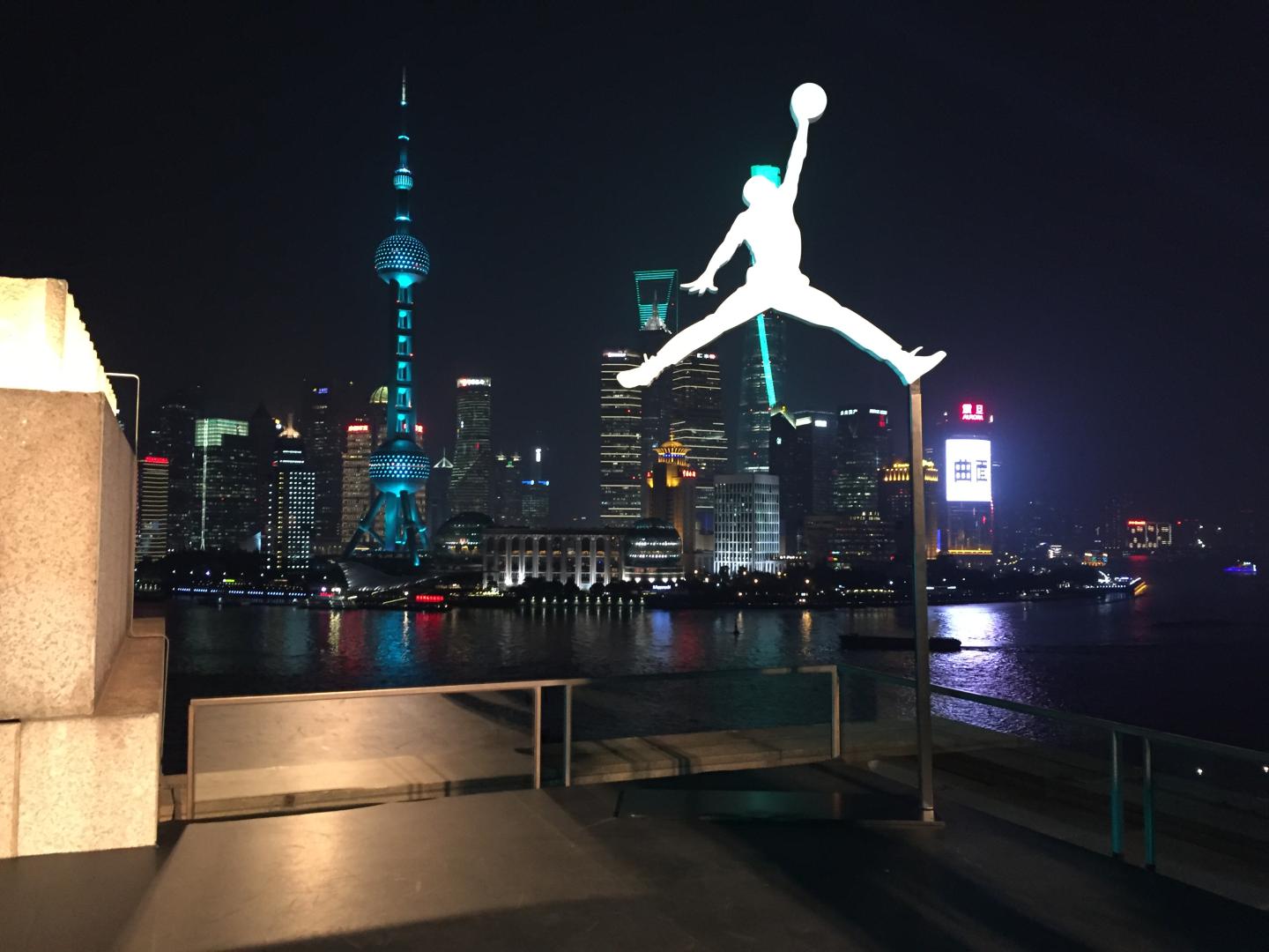 The Jordan Brand logo silhouetted against Shanghai's skyline.