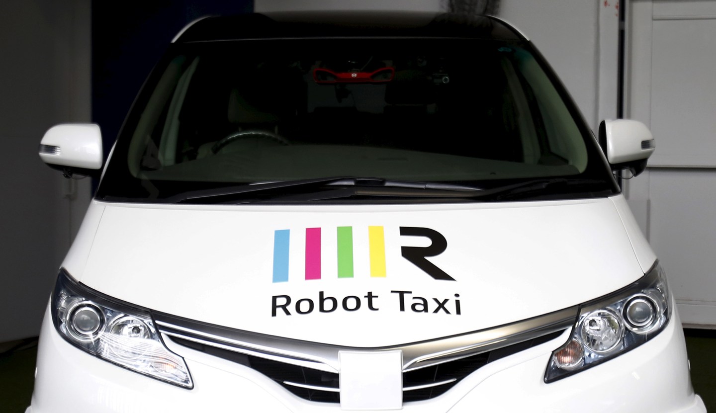 The company logo of Robot Taxi Inc. is seen on its Robot Taxi, a self-driving taxi based on a Toyota Estima car body, during an unveiling ceremony in Yokohama,