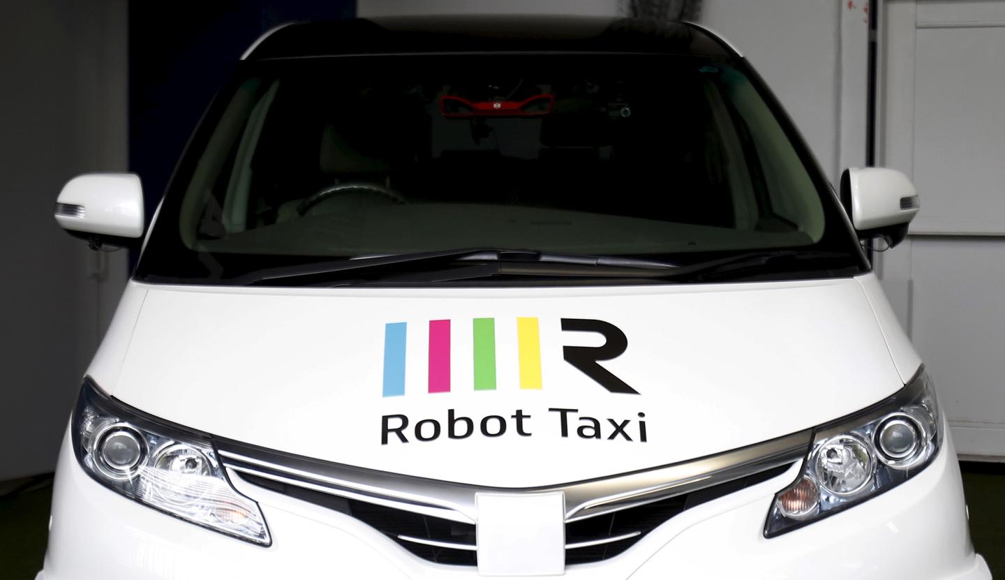 The company logo of Robot Taxi Inc. is seen on its Robot Taxi, a self-driving taxi based on a Toyota Estima car body, during an unveiling ceremony in Yokohama,