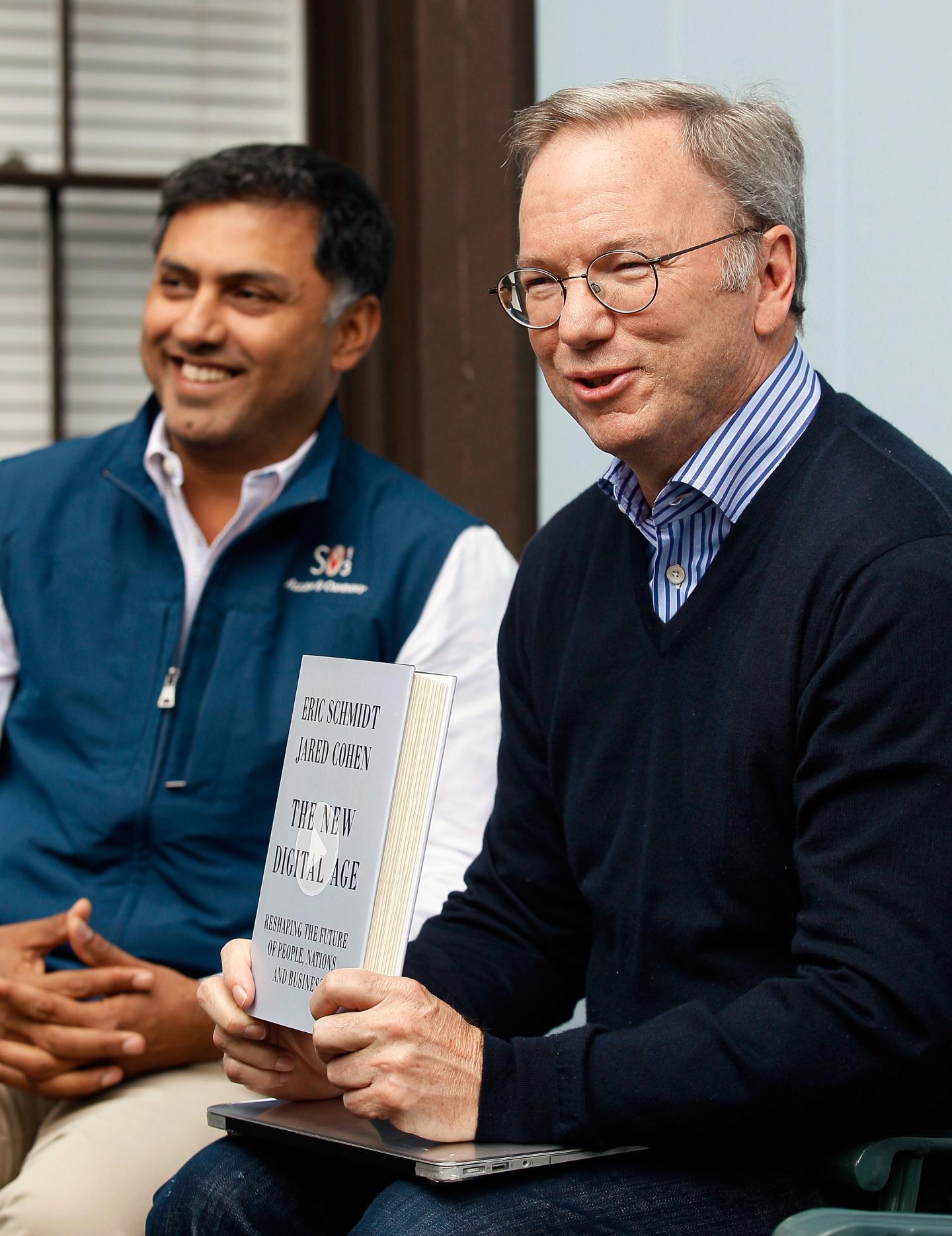 Eric Schmidt, executive chairman of Google holds up his book with Nikesh Arora, Google chief business officer at the annual Allen and Co. conference in Sun Valley
