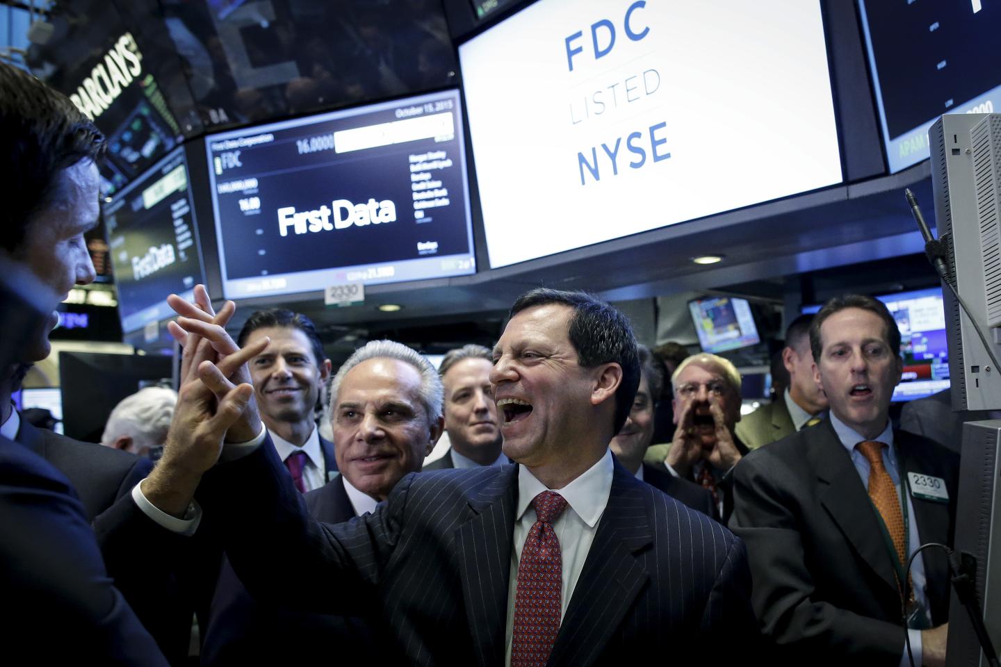 First Data Chairman and Chief Executive Frank Bisignano (C) celebrates during his company's initial public offering on the floor of the New York Stock Exchange
