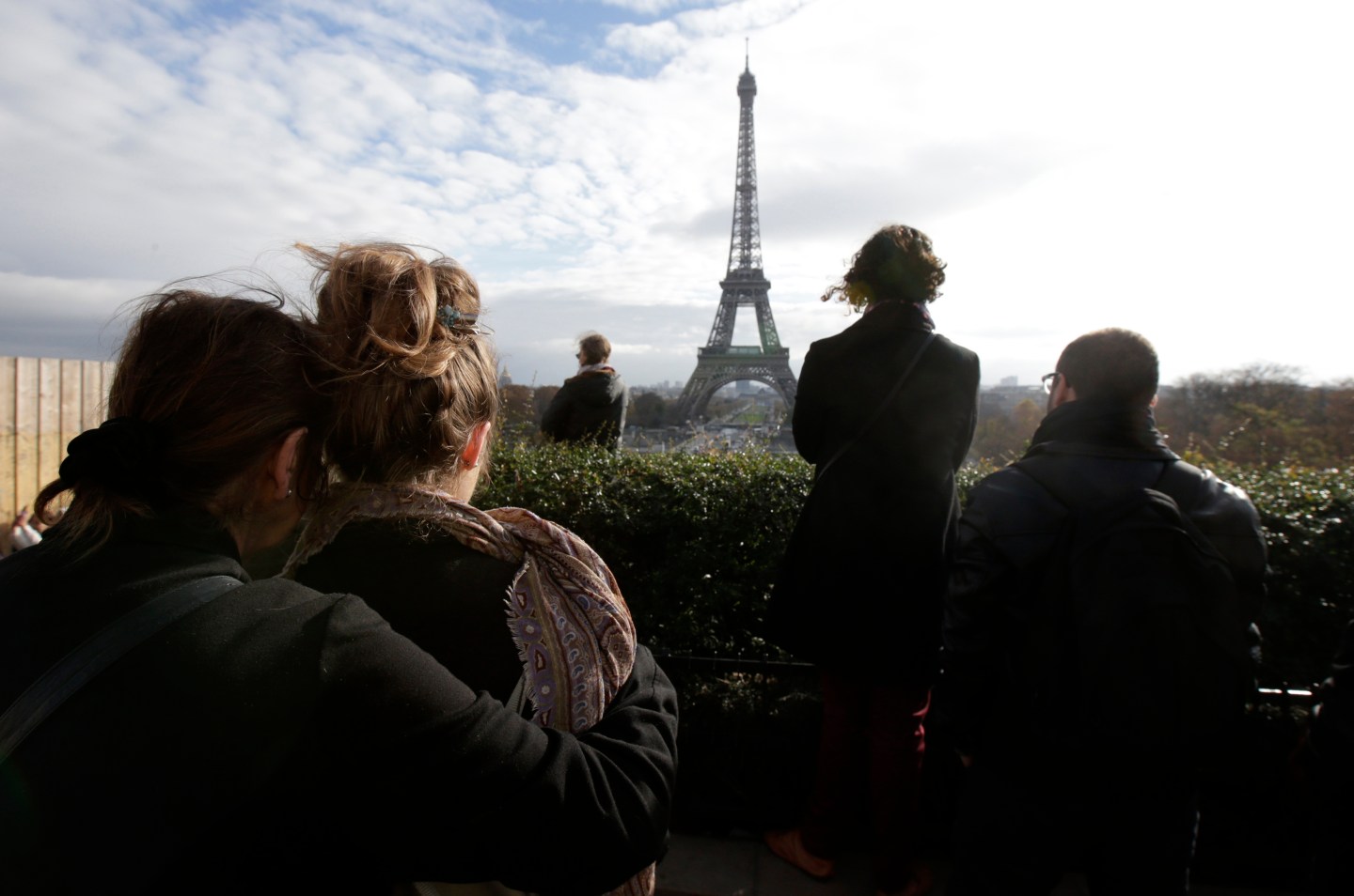 People observe a minute of silence at the Trocadero in front the Eiffel Tower to pay tribute to the victims of the series of deadly attacks on Friday in Paris