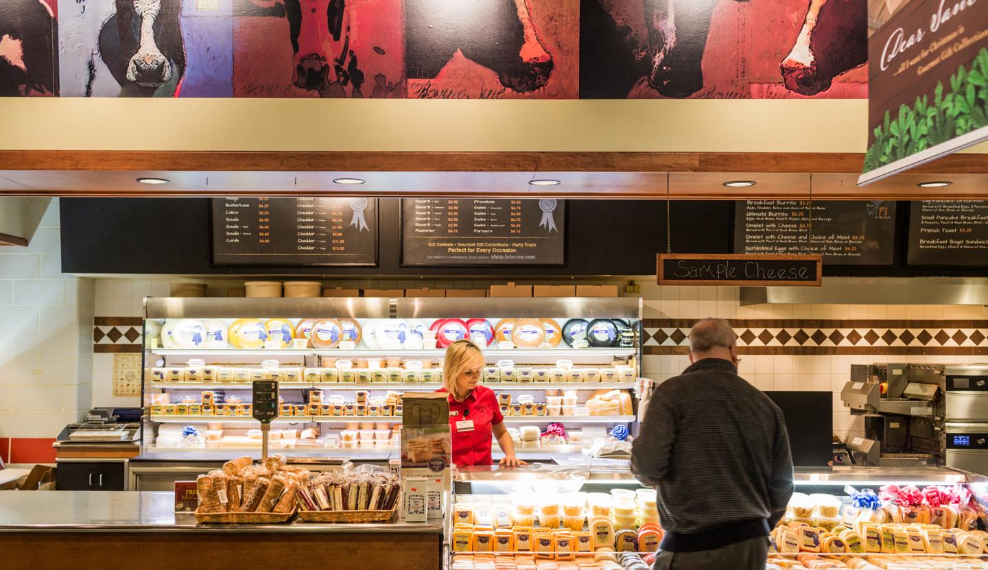Kimberly Corning helps a customer pick out cheese made from the dairy's cow milk in the cafe and gift shop at Fair Oaks Dairy in Fair Oaks, Ind., on Janurary 7, 2016.