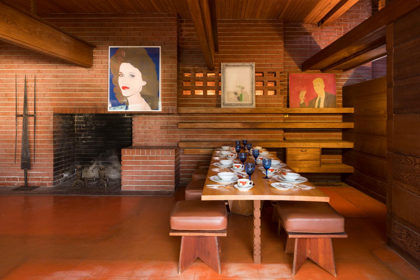 Interior of Living-Dining area. Left to right: Works of art by Oliver Andrews, Andy Warhol, David Hockney, and Alex Katz. China by Frank Lloyd Wright.