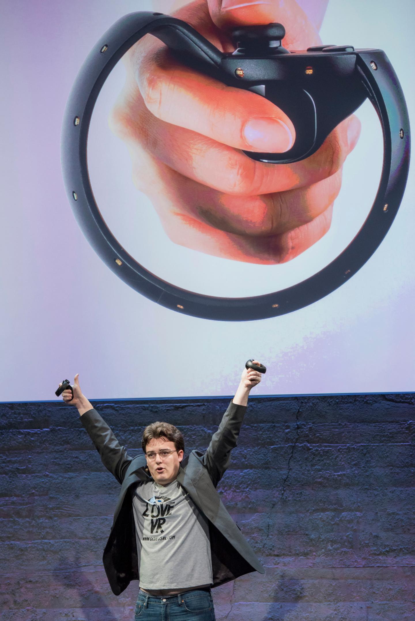 Palmer Luckey, co-founder of Oculus VR. Inc. and creator of the Oculus Rift, holds up the Oculus Touch controller as he speaks during the Oculus VR Inc. "Step Into The Rift" event in San Francisco, California, U.S., on Thursday, June 11, 2015. Facebook Inc.'s Oculus virtual-reality headsets will work with Microsoft Corp.'s Windows 10 and use the software maker's wireless Xbox game controller. Photographer: David Paul Morris/Bloomberg *** Local Caption *** Palmer Luckey