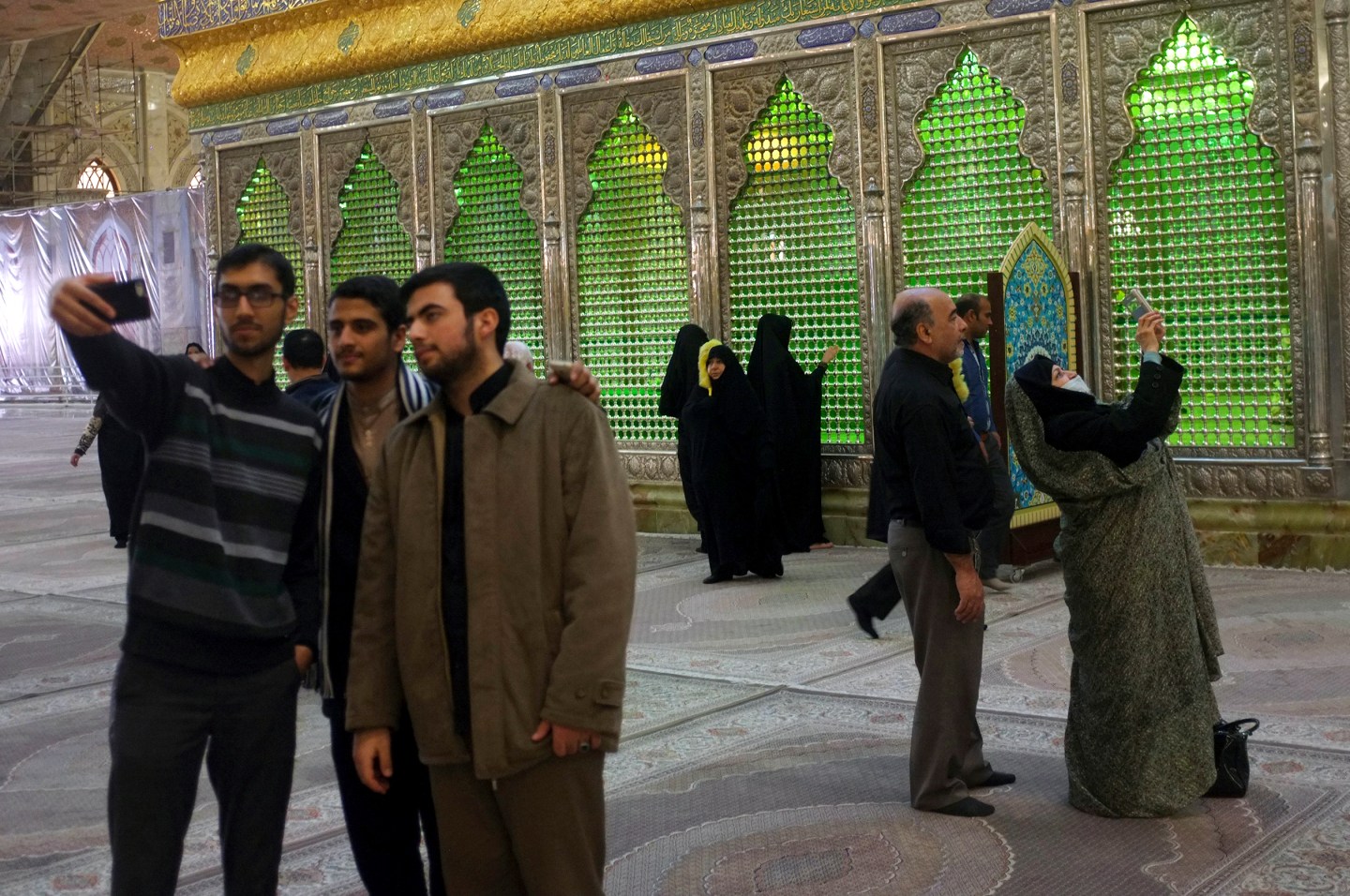 Visitors to the Ayatolah Khomeini's shrine in Tehran take selfies. 