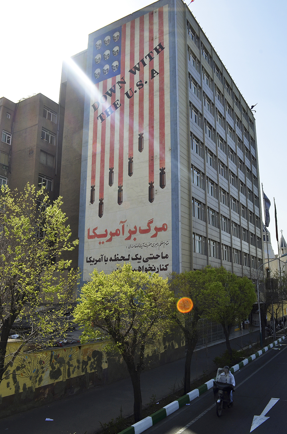 Symbols of antipathy to the U.S. coexist with signs of a yearning for a Western lifestyle. The Persian text read "Iran will not deal with America even for a second" 