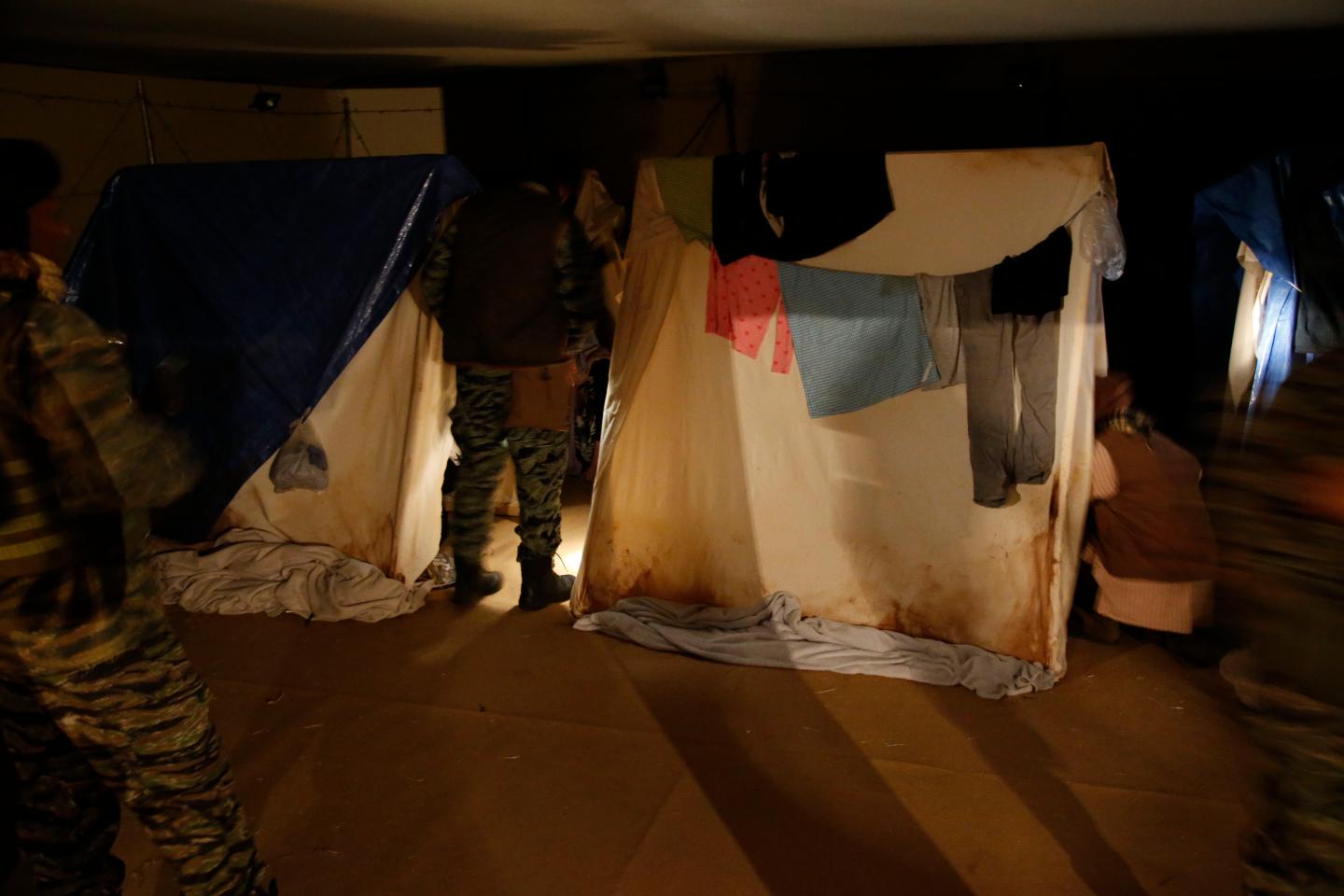 Participants wait in their tents at 'nighttime' in the camp at A Day in the Life of a Refugee.