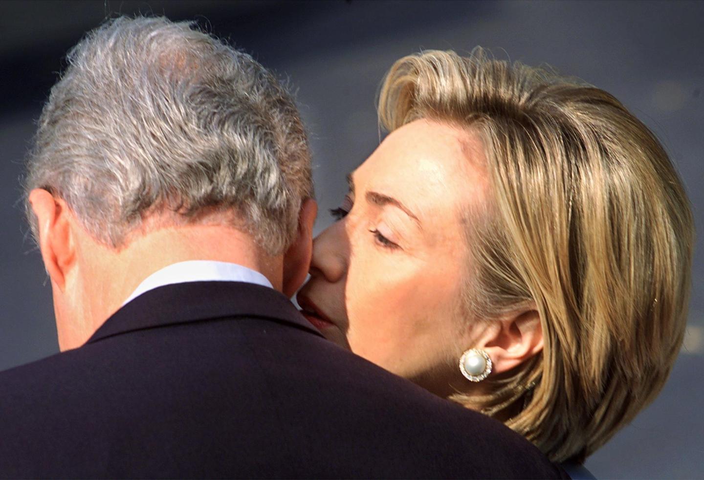 US First Lady Hillary Rodham Clinton whispers to U
