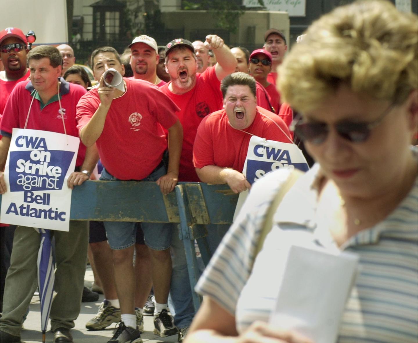 Striking telephone workers represented by the Communications Workers of America verbally harass a woman in front of Verizon Communications'' headquarters in New York Aug. 7, 2000.