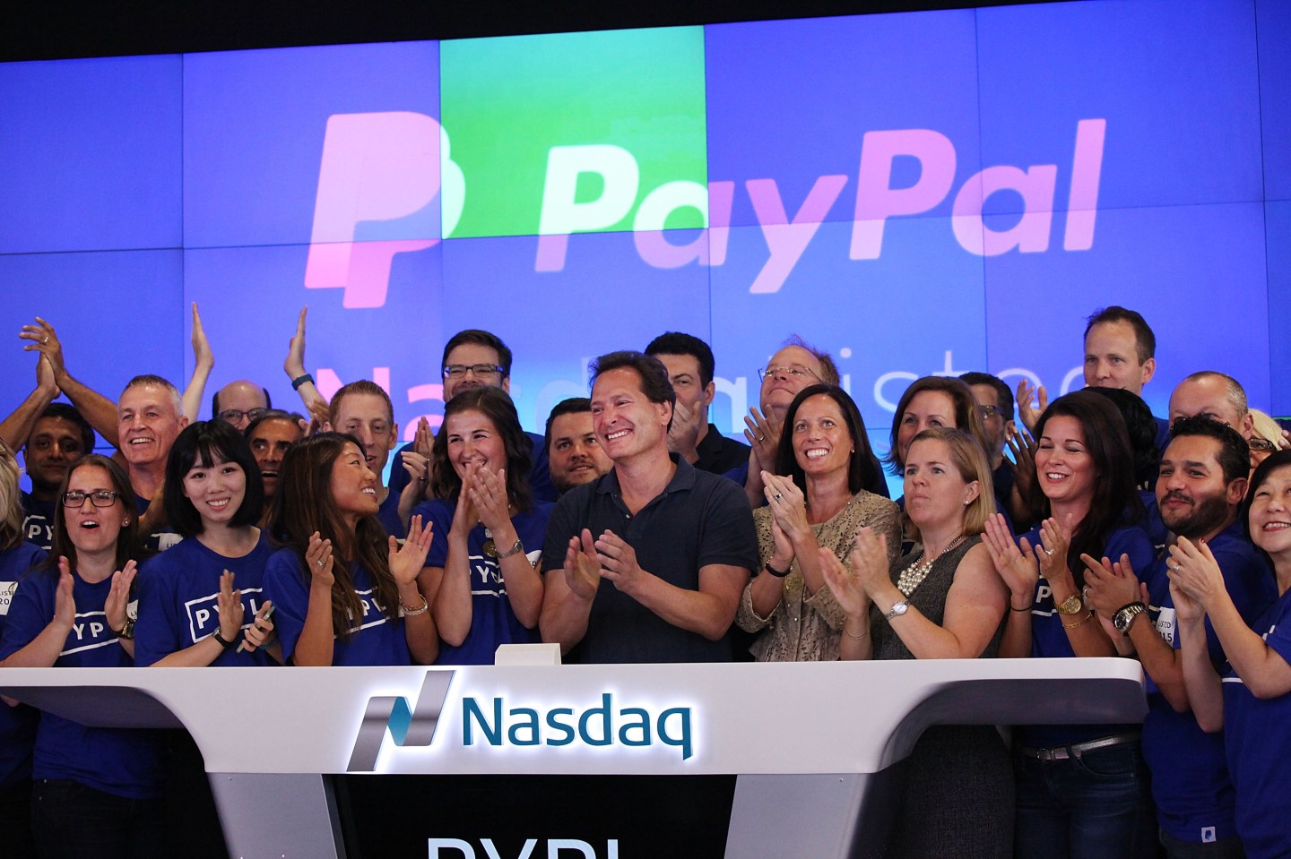 PayPal CEO Dan Schulman (center, with hands clasped) with co-workers on July 20, 2015, the day PayPal's stock began trading on the Nasdaq.