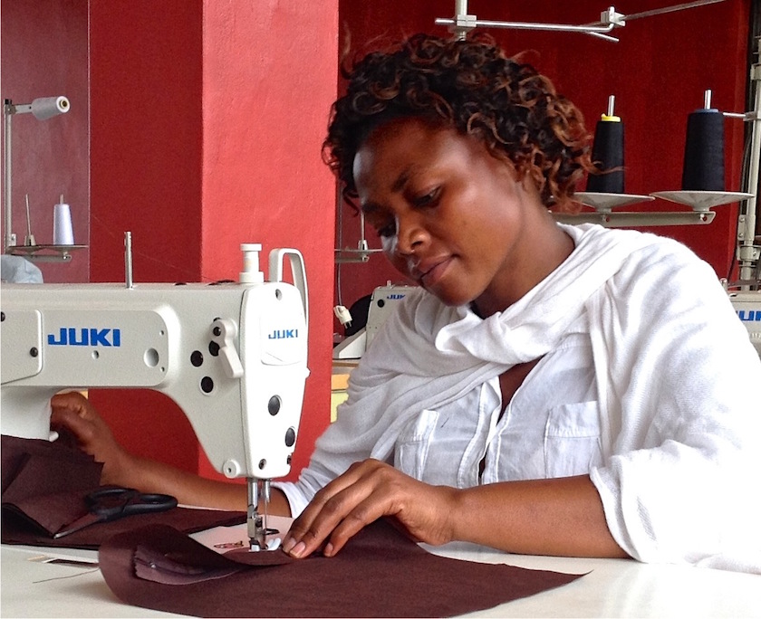 A Rwandan woman who is taking part in Gahaya Links, a cooperative producing hard woven basketry, clothing, and bead designs.