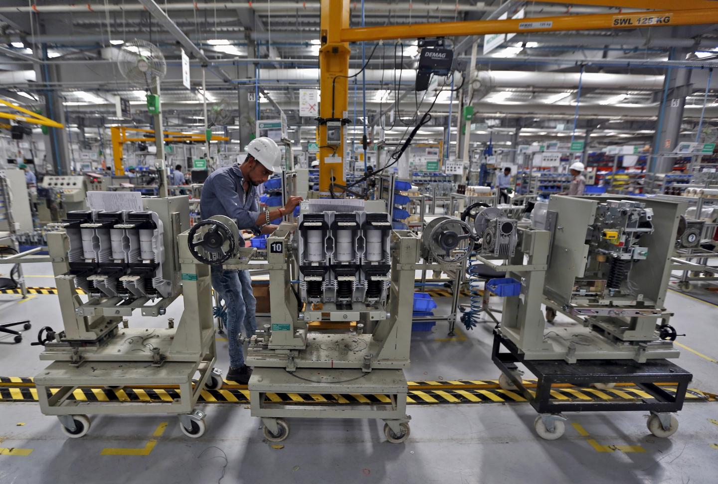 An employee assembles medium voltage switchgears inside the plant of Schneider Electric Infrastructure Ltd. on the outskirts of Vadodara in Gujarat