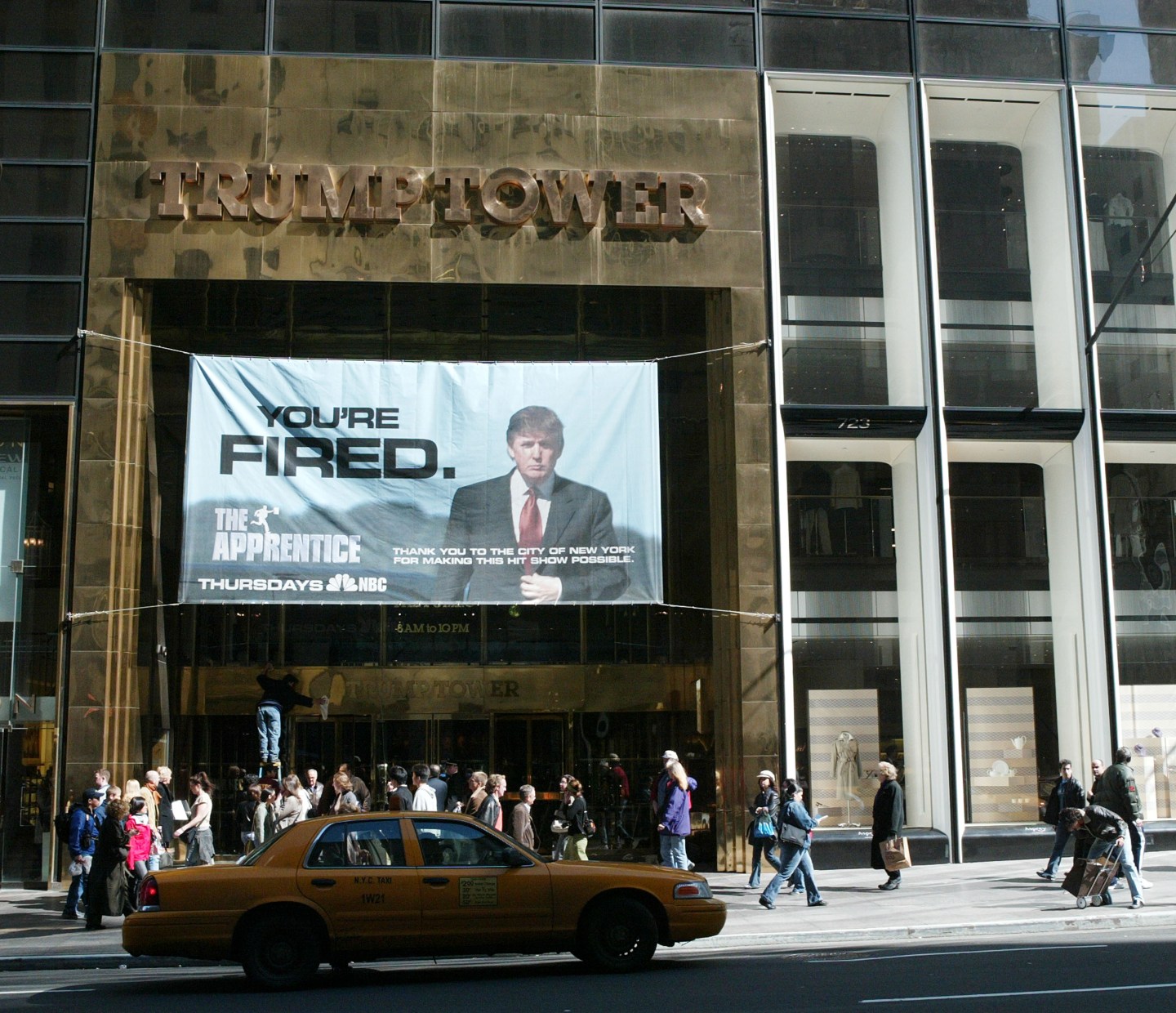 A sign advertising the television show 'The Apprentice' hangs at Trump Towers in 2004.