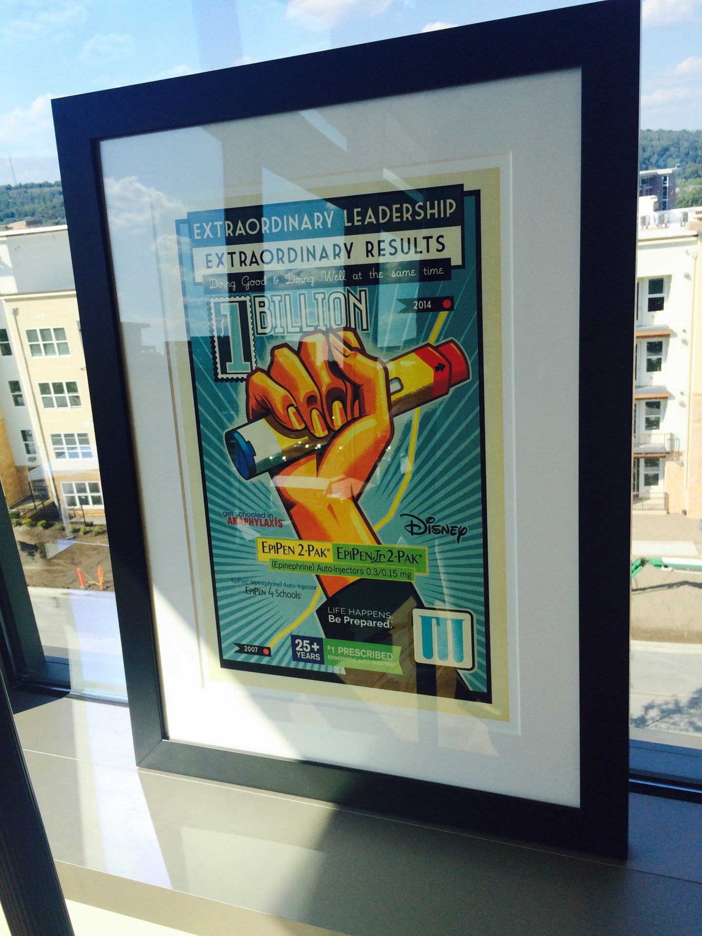 A poster commemorating EpiPen's $1 billion annual sales milestone is displayed in Mylan CEO Heather Bresch's office in Canonsburg, PA, with the slogan "Extraordinary leadership, extraordinary results: Doing good & doing well at the same time."