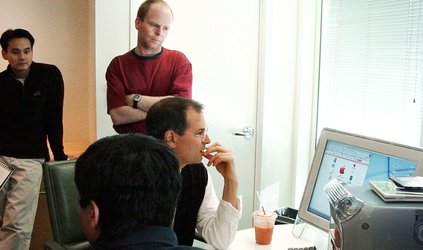 1999, Product Review: Jobs scrutinizes the "dock" of icons that appears on the bottom of the screen of Apple's OS X user interface with an anxious team of engineers, designers, and marketers. 