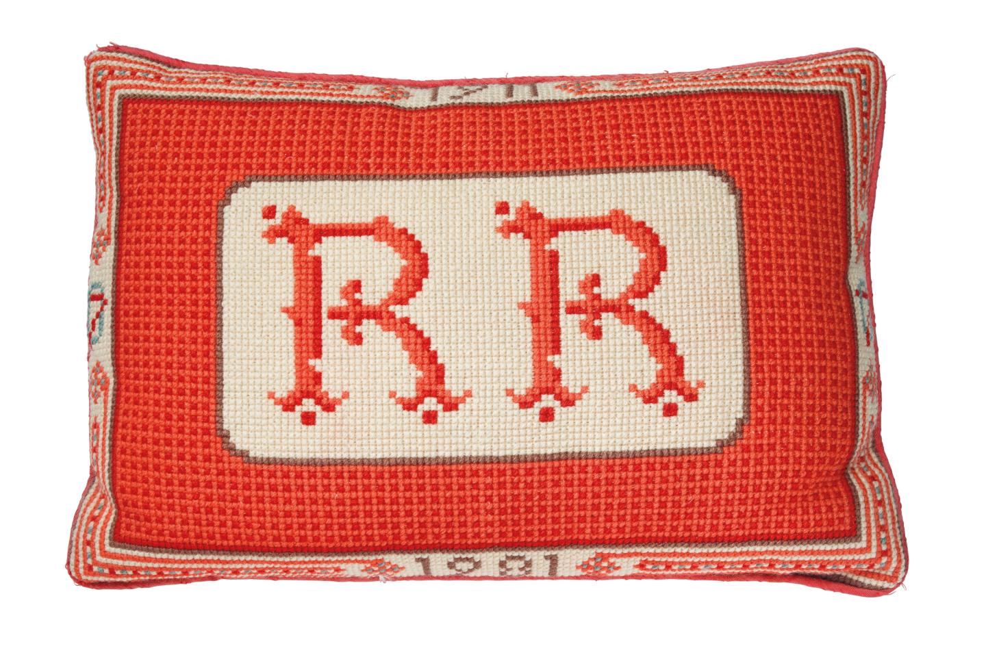 President Reagan's 70th birthday present, a red monogrammed needlepoint cushion. It sold for $25,000.