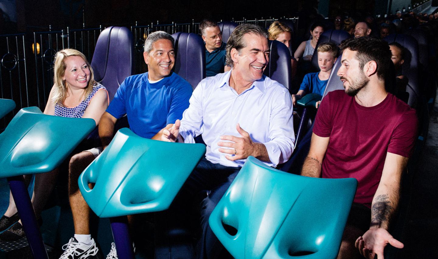 Joel Manby, second from right, prepares to ride "Mako" the fastest roller coaster in Orlando. 