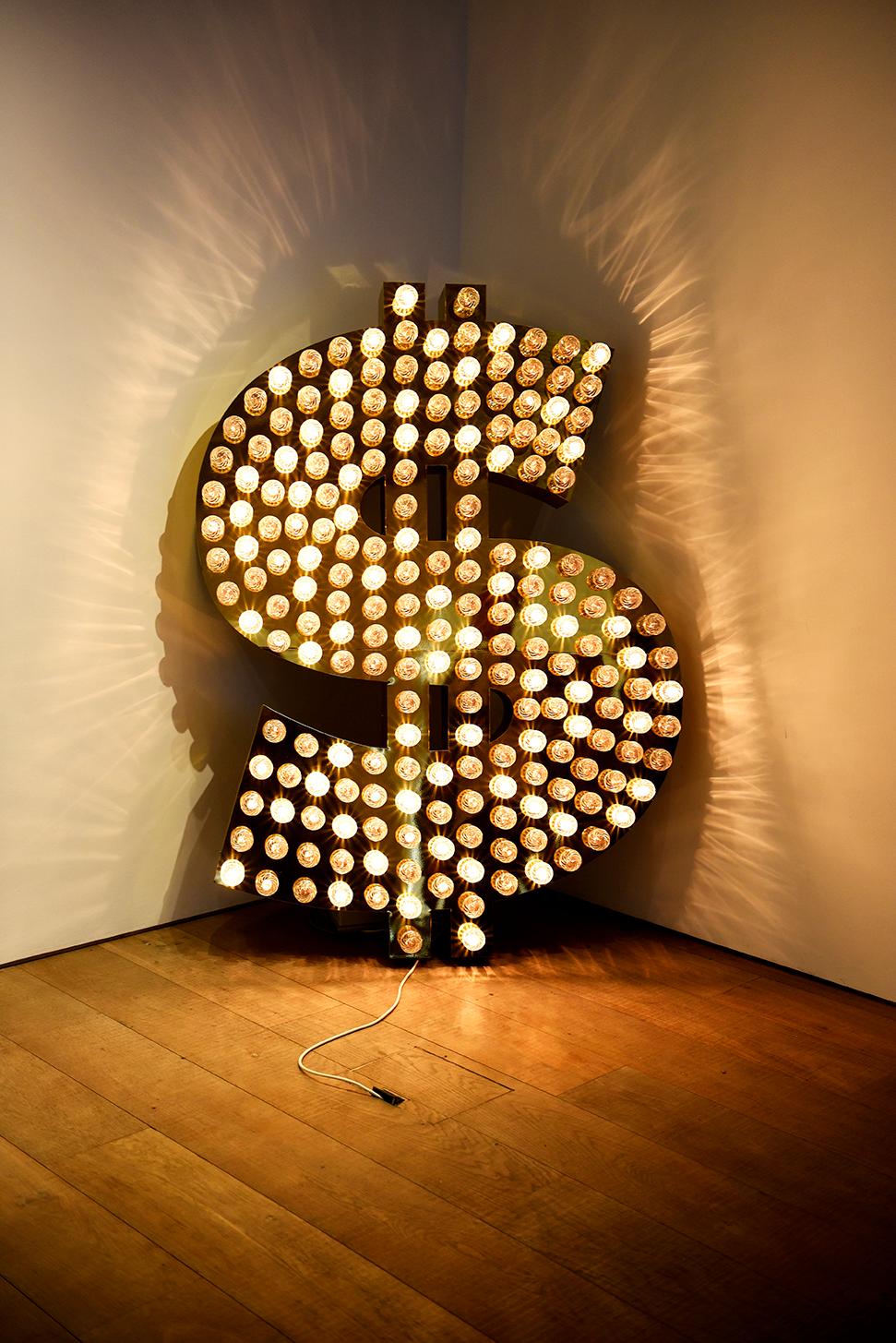 Tim Noble and Sue Webster's '$, 2001' sold above estimate for $171,000 in a June 2015 Sotheby's sale in London, as part of an exhibition of pieces inspired by the US Dollar.