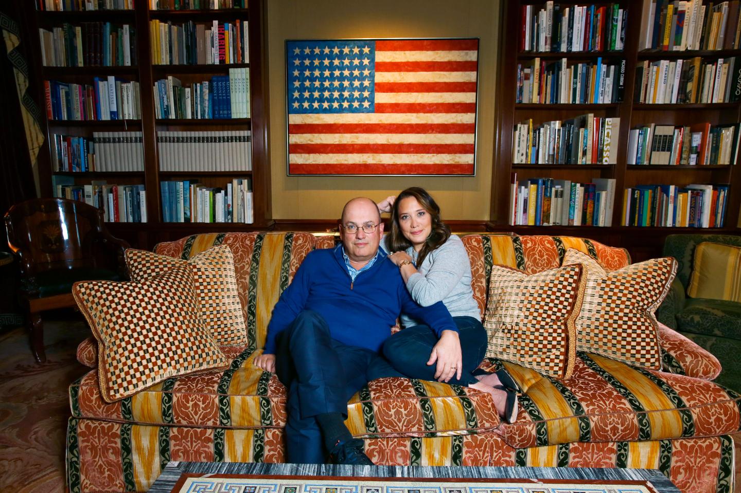 Cohen and wife Alex, sitting in front of Jasper Johns' "Flag" (1958). 