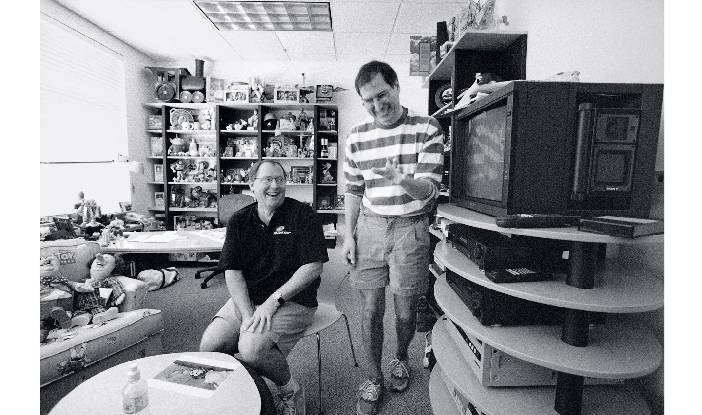 Jobs laughs with Chief Creative Officer John Lasseter in the latter's office at Pixar in August 1997.