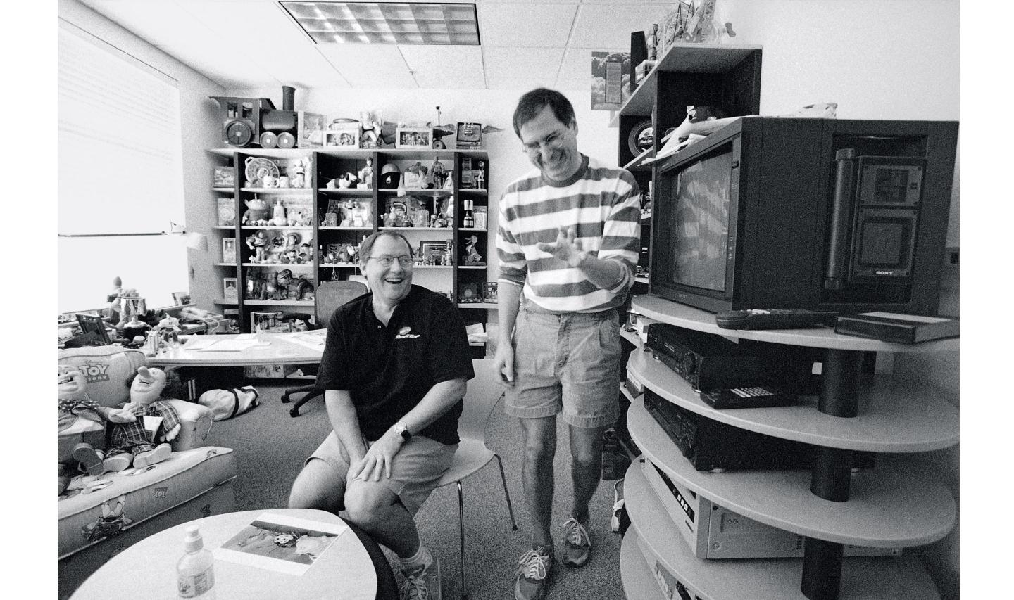 Jobs laughs with Chief Creative Officer John Lasseter in the latter's office at Pixar in August 1997.