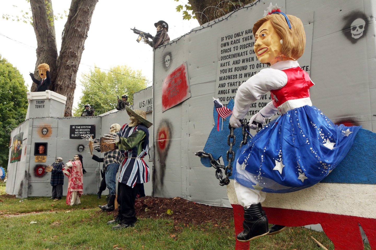 A Halloween display featuring a border wall and figures of Donald Trump, Hillary Clinton and Bernie Sanders is seen on the property of Matt Warshauer in West Hartford