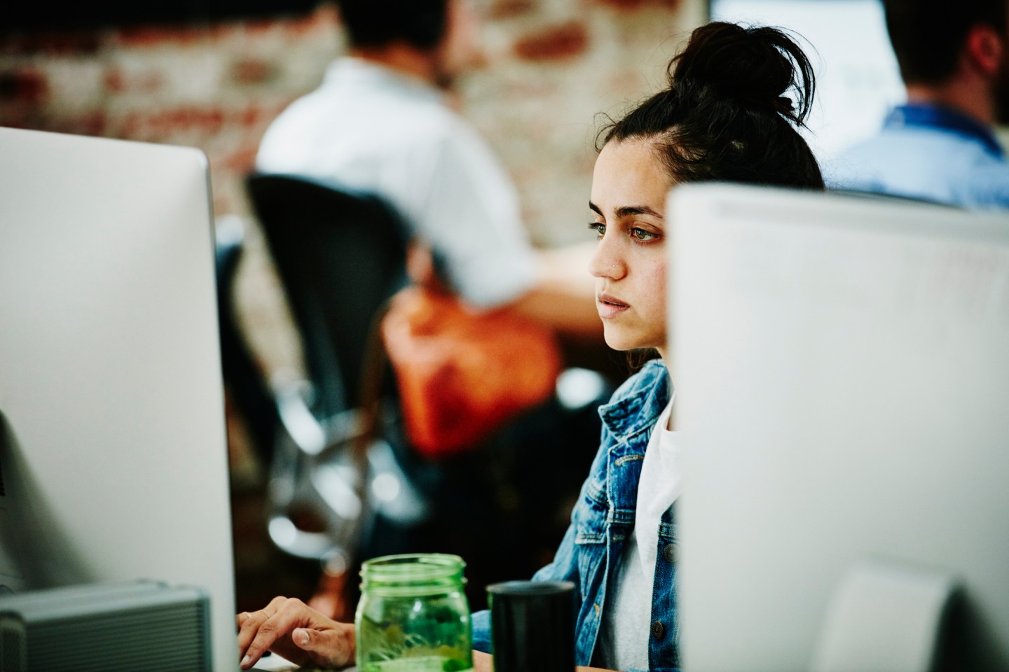 Programmer working on coding project on computer