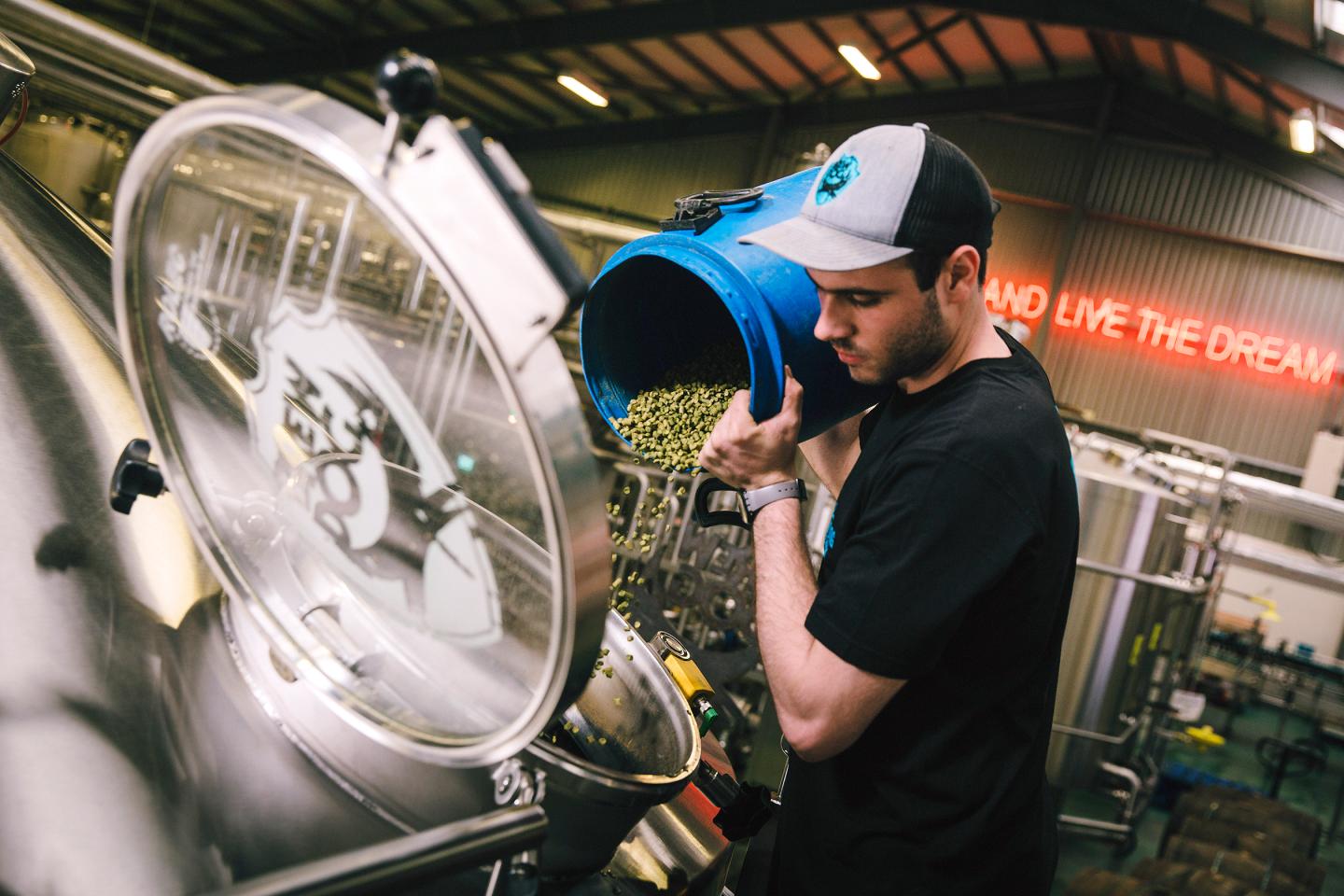 Pouring hops at the company’s Scottish brewery. 