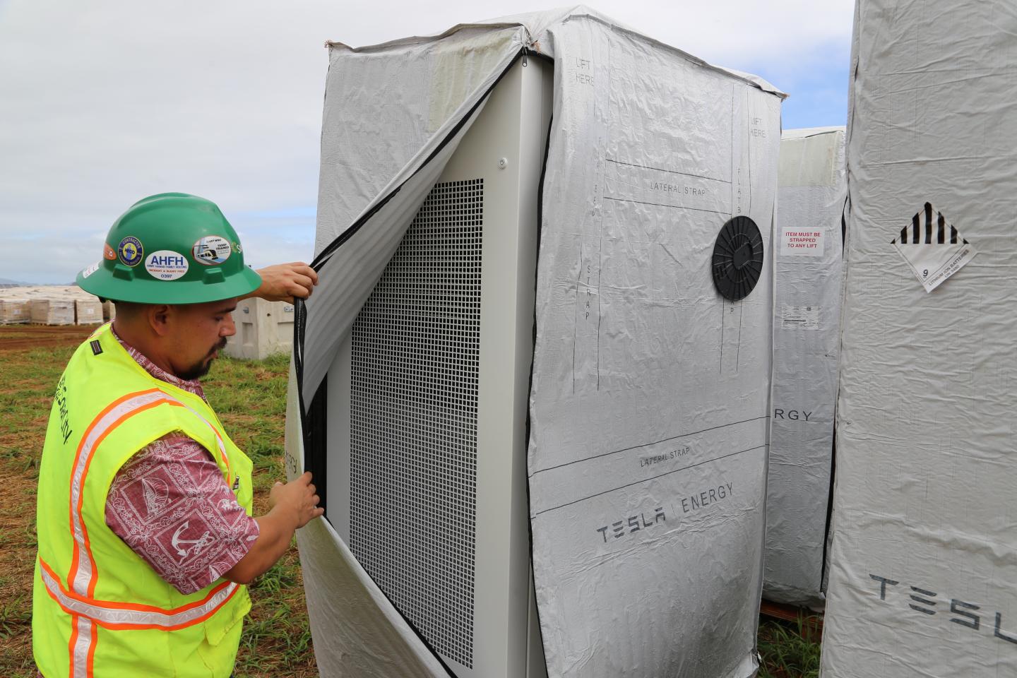 SolarCity's Senior Commercial Project Manager, Danny Valdez, checks out one of Tesla's Powerwalls at a solar farm on the island of Kauai.