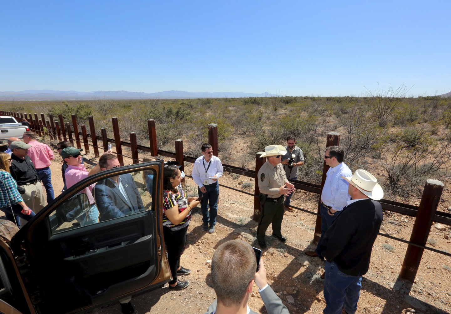 Republican Presidential candidate Ted Cruz stands along the United States border with Mexico as he speaks to Cochise County Sheriff Mark Dannels and Arizona State representative David Gowan near Douglas, Arizona